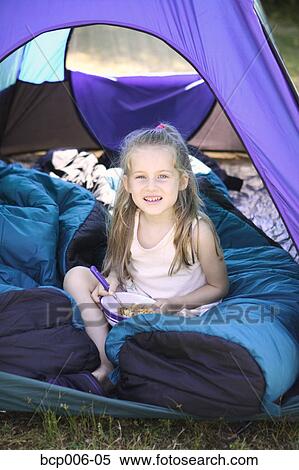 Smiling young girl looking out from inside a tent. View Large Photo Image Stock Photography - Smiling young girl looking out from inside a tent.. Fotosearch