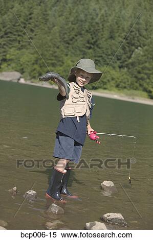 Young boy fishing in a river. View Large Photo Image Stock Photography - Young boy fishing in a river.. Fotosearch