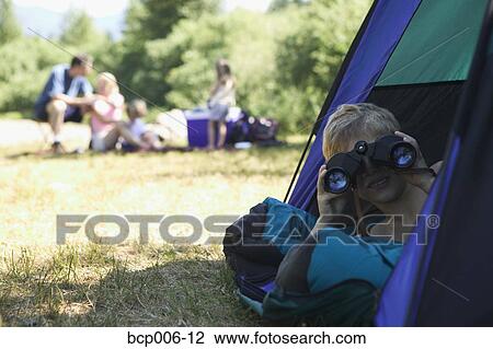 Young camper looking through binoculars. View Large Photo Image Stock Image - Young camper looking through binoculars. . Fotosearch