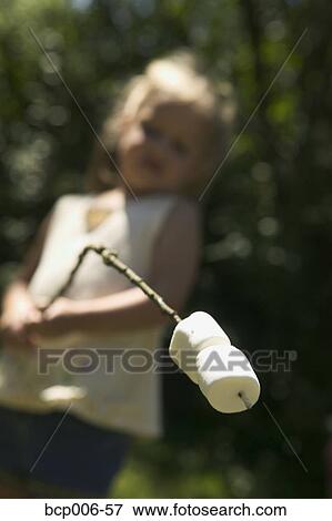 Young girl about to roast marshmallows. View Large Photo Image Stock Photo - Young girl about to roast marshmallows.. Fotosearch