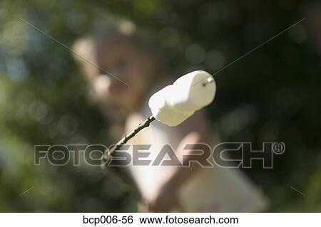 Young girl about to roast marshmallows. View Large Photo Image Stock Photograph - Young girl about to roast marshmallows.. Fotosearch