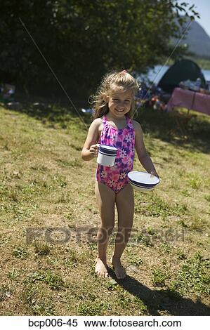 Young girl carrying food and drink at a campsite. View Large Photo Image Stock Photography - Young girl carrying food and drink at a campsite.. Fotosearch