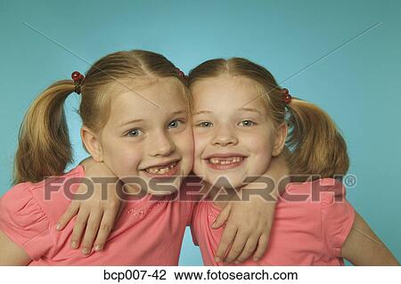Portrait of twin girls, cheek to cheek. View Large Photo Image Stock Image - Portrait of twin girls, cheek to cheek.. Fotosearch