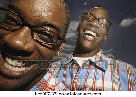 Portrait of twin teenage boys wearing glasses. View Large Photo Image Stock Photo - Portrait of twin teenage boys wearing glasses.. Fotosearch