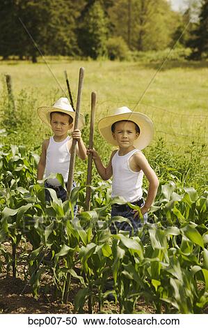 Twin boys working on the family farm. View Large Photo Image Stock Image - Twin boys working on the family farm.. Fotosearch