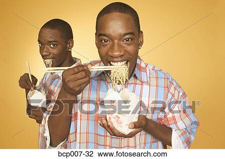 Twin teen boys eating noodles from cartons. View Large Photo Image Stock Image - Twin teen boys eating noodles from cartons.. Fotosearch