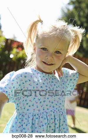 Young, blonde girl outdoors in a dress. View Large Photo Image Stock Photo - Young, blonde girl outdoors in a dress.. Fotosearch