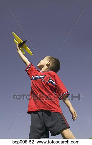 Young boy flying a model airplane. View Large Photo Image Stock Image - Young boy flying a model airplane.. Fotosearch