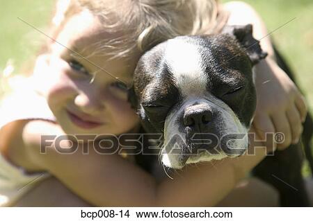 Young girl hugging her dog. View Large Photo Image Picture - Young girl hugging her dog.. Fotosearch
