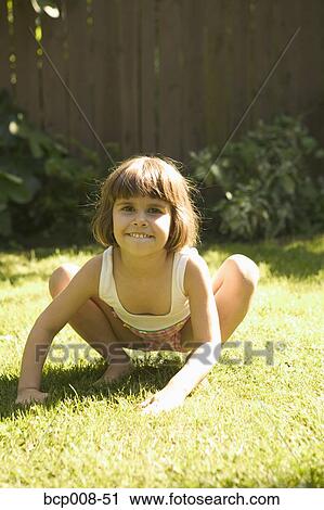 Young girl imitating a frog. View Large Photo Image Stock Image - Young girl imitating a frog.. Fotosearch