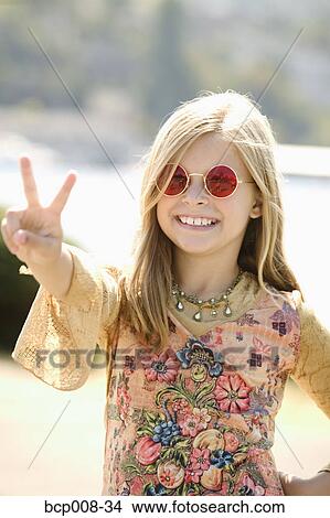 Young girl in sunglasses making a peace sign. View Large Photo Image Picture - Young girl in sunglasses making a peace sign.. Fotosearch