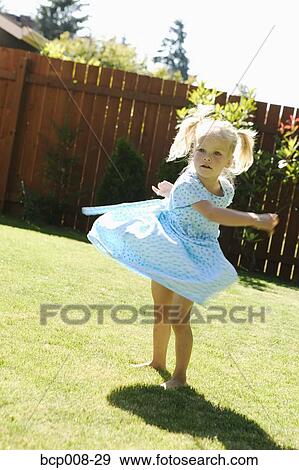 Young girl twirling in the backyard. View Large Photo Image Stock Photo - Young girl twirling in the backyard.. Fotosearch