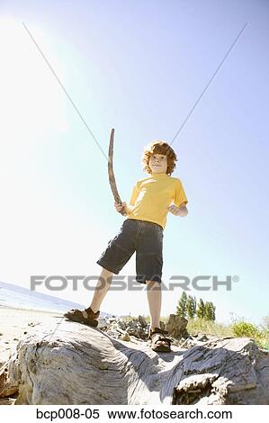 Young, red-headed boy holding a stick. View Large Photo Image Stock Photography - Young, red-headed boy holding a stick.. Fotosearch