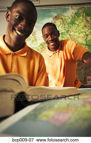 Portrait of twin teenage brothers in a classroom. View Large Photo Image Stock Photo - Portrait of twin teenage brothers in a classroom.. Fotosearch