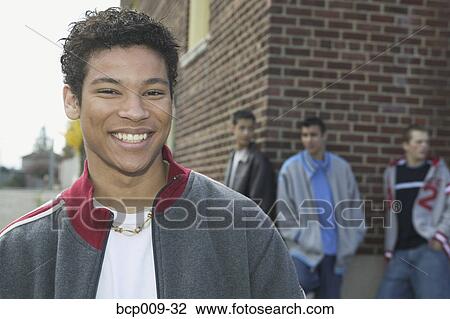 Smiling teenage boy and his pals. View Large Photo Image Stock Image - Smiling teenage boy and his pals.. Fotosearch
