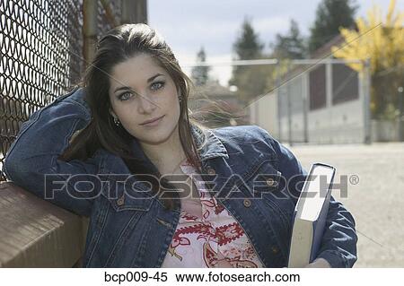 Stock Photography - Teenage girl standing in the schoolyard.. Fotosearch