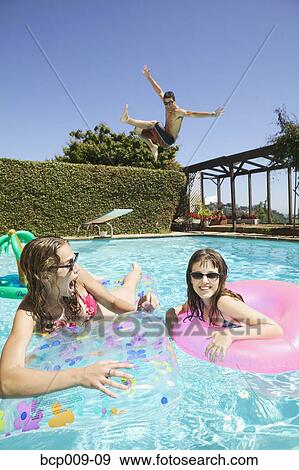 Teenagers getting crazy in a swimming pool. View Large Photo Image Stock Photo - Teenagers getting crazy in a swimming pool.. Fotosearch