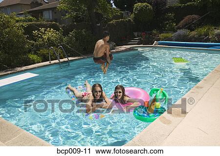 Teenagers playing in a swimming pool. View Large Photo Image Stock Image - Teenagers playing in a swimming pool.. Fotosearch