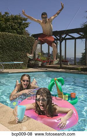 Teenagers playing in a swimming pool. View Large Photo Image Stock Photo - Teenagers playing in a swimming pool.. Fotosearch