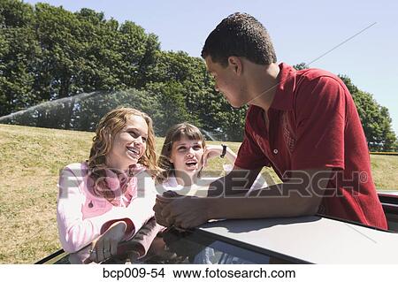 Three teenage friends hanging out. View Large Photo Image Picture - Three teenage friends hanging out.. Fotosearch