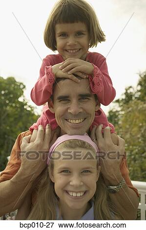 A father with his two daughters. View Large Photo Image Stock Photo - A father with his two daughters.. Fotosearch
