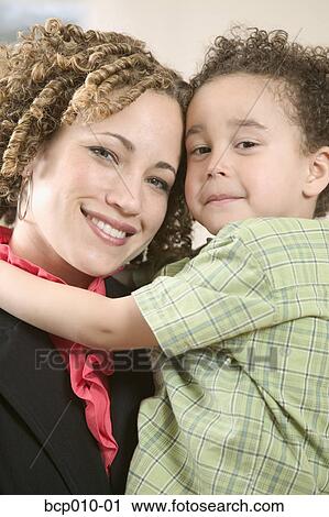 Close-up portrait of a mother with her young son. View Large Photo Image Stock Image - Close-up portrait of a mother with her young son.. Fotosearch