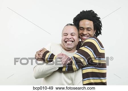 Father and grown son hugging. View Large Photo Image Stock Photo - Father and grown son hugging.. Fotosearch