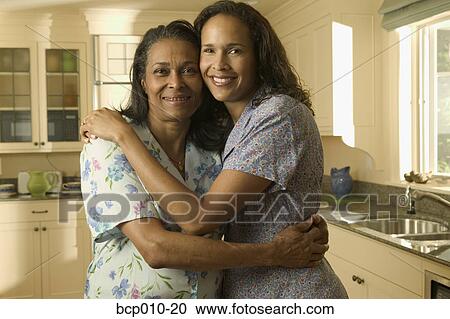 Mother and her adult daughter embrace. View Large Photo Image Stock Image - Mother and her adult daughter embrace.. Fotosearch