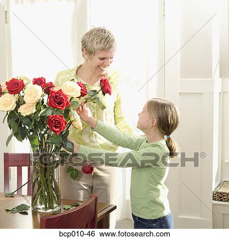 Mother arranging roses with her daughter. View Large Photo Image Stock Photograph - Mother arranging roses with her daughter.. Fotosearch