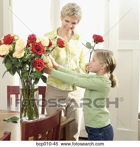 Mother arranging roses with her daughter. View Large Photo Image Stock Photography - Mother arranging roses with her daughter.. Fotosearch