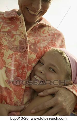 Mother hugging her daughter. View Large Photo Image Stock Photograph - Mother hugging her daughter.. Fotosearch