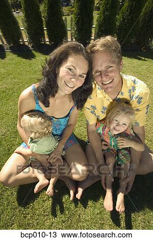 Outdoors portrait of parents and two toddlers. View Large Photo Image Stock Image - Outdoors portrait of parents and two toddlers.. Fotosearch
