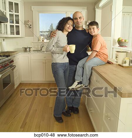 Arkistovalokuva - Parents and their young son in the kitchen.. Fotosearch
