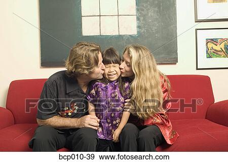 Parents kissing their daughter. View Large Photo Image Stock Photo - Parents kissing their daughter.. Fotosearch