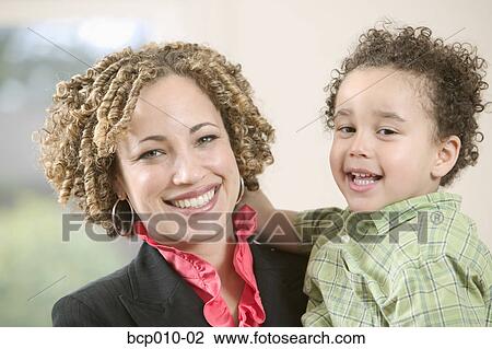 Stock Image - Portrait of a mother and her young son.. Fotosearch
