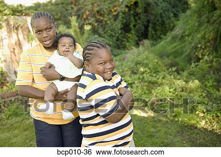 Portrait of young family members. View Large Photo Image Stock Photograph - Portrait of young family members.. Fotosearch