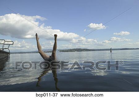 Stock Photo - A diver's legs sticking out of a lake.. Fotosearch