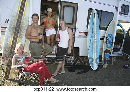 A group of young adults with surfboards and a motor home. View Large Photo Image Stock Image - A group of young adults with surfboards and a motor home.. Fotosearch