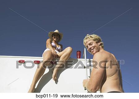 Couple hanging out on their motor home. View Large Photo Image Stock Photo - Couple hanging out on their motor home.. Fotosearch