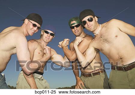 Four young men flexing their muscles. View Large Photo Image Stock Photography - Four young men flexing their muscles.. Fotosearch