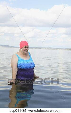 Large woman standing in a lake. View Large Photo Image Stock Photography - Large woman standing in a lake.. Fotosearch