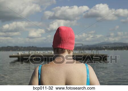 Stock Image - Rear view of a large woman in a bathing suit.. Fotosearch