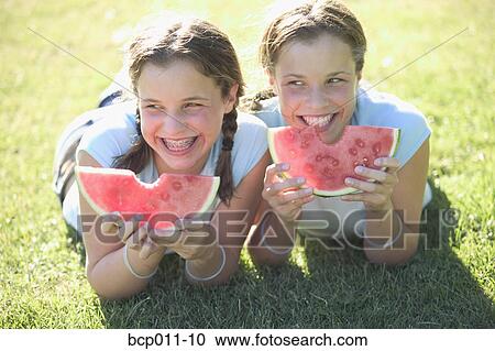 Teenage twin girls eating watermelon. View Large Photo Image Stock Image - Teenage twin girls eating watermelon.. Fotosearch
