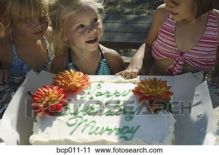 Three young girls with a birthday cake. View Large Photo Image Stock Image - Three young girls with a birthday cake.. Fotosearch