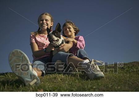 Two young with their pet dog. View Large Photo Image Stock Photo - Two young with their pet dog.. Fotosearch