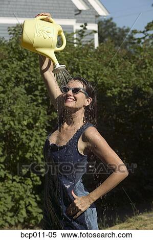 Woman pouring water over herself outdoors. View Large Photo Image Stock Photography - Woman pouring water over herself outdoors.. Fotosearch