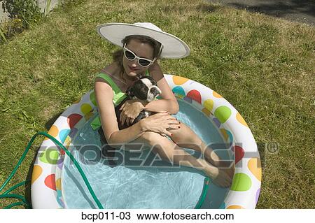 Woman sitting with her dog in backyard baby pool. View Large Photo Image Stock Image - Woman sitting with her dog in backyard baby pool.. Fotosearch