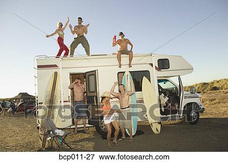 Stock Photo - Young people dancing on and around a motor home.. Fotosearch