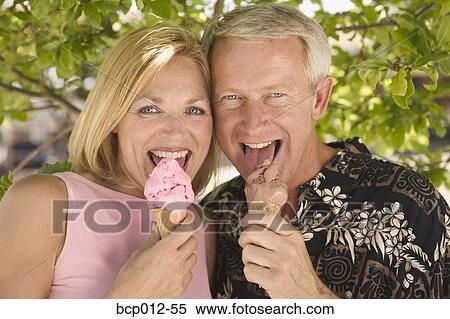 Couple eating ice cream cones. View Large Photo Image Stock Photography - Couple eating ice cream cones.. Fotosearch