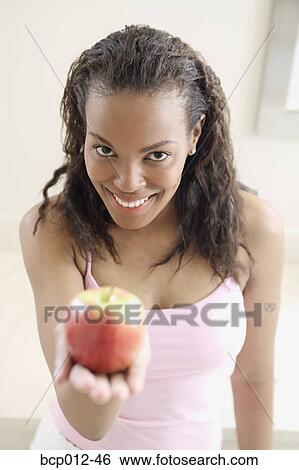Stock Photograph - Family preparing food and eating together in the kitchen. . Fotosearch